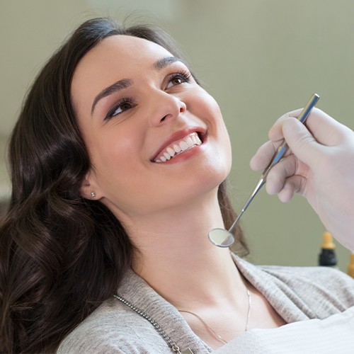 Smiling woman receiving dental care