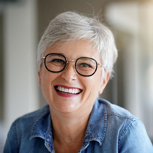 Woman with glasses smiling with All-on-4 in Minot, MD