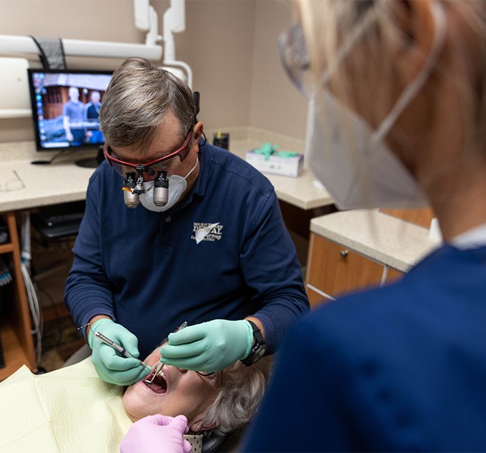 Man and woman smiling after restorative dentistry