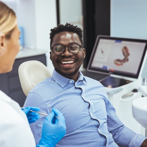 Patient smiling at dentist during dental exam