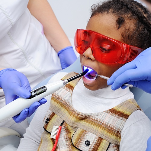 Child receiving dental sealants