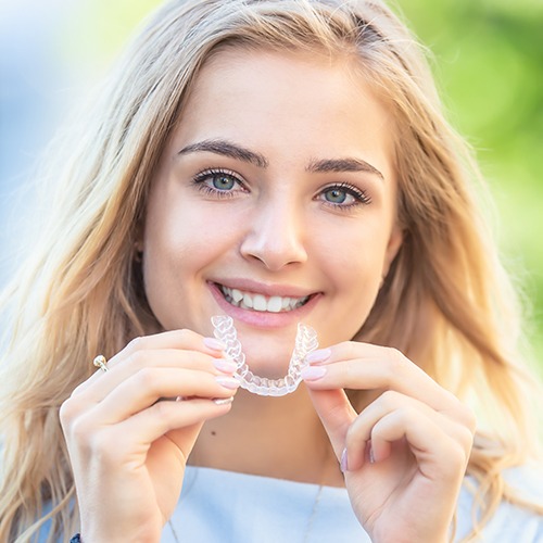 Woman placing an Invisalign tray