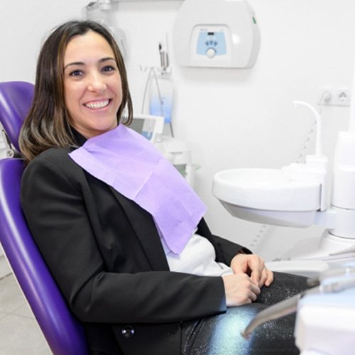 Female patient sitting in dental chair waiting for treatment