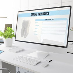 Large computer monitor with a dental insurance form on it