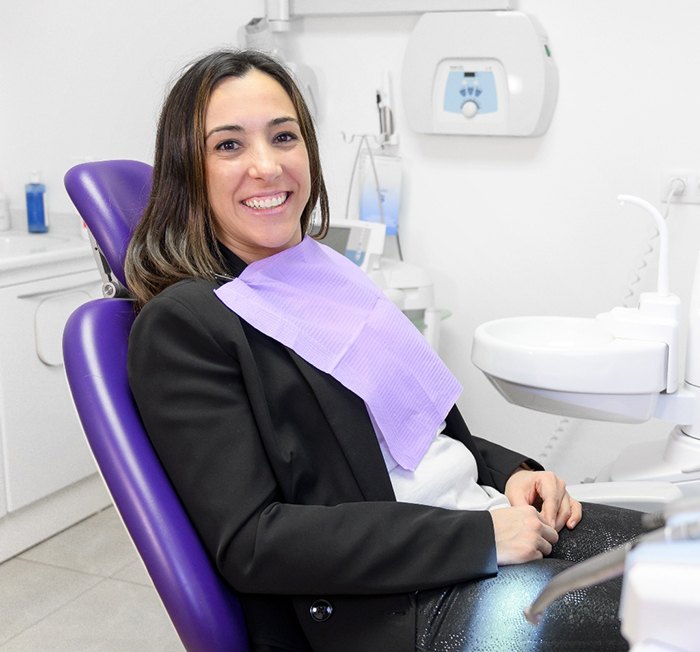 Female dental patient smiling and waiting for treatment