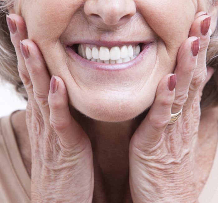 a person holding their cheeks and smiling