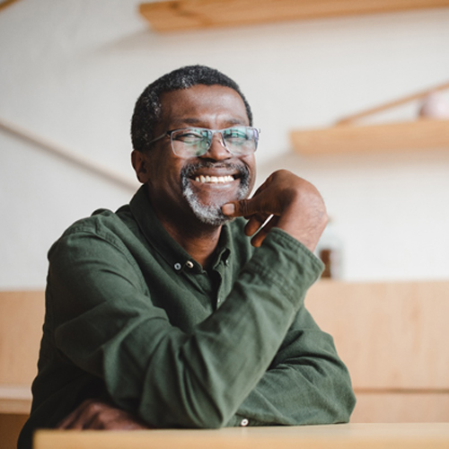 smiling person sitting at a table