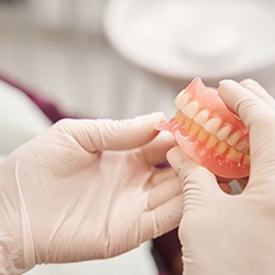 Technician checking dentures in Minot 