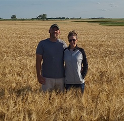 Doctor Brekhus and her husband standing in a field