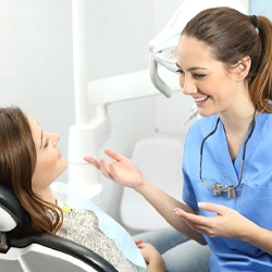 dental hygienist talking to patient