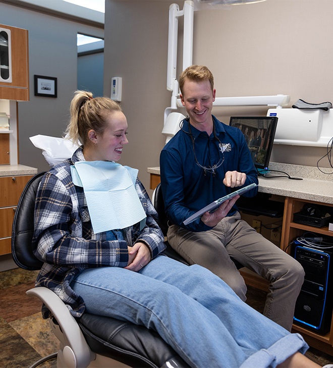 Woman laughing with dentist in dental treatment room