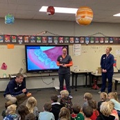 Dental team members giving presentation in elementary school classroom