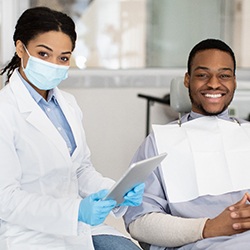 patient smiling while sitting in treatment chair 