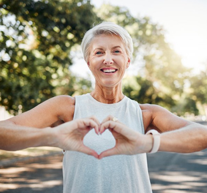 Lady makes shape of heart with her hands