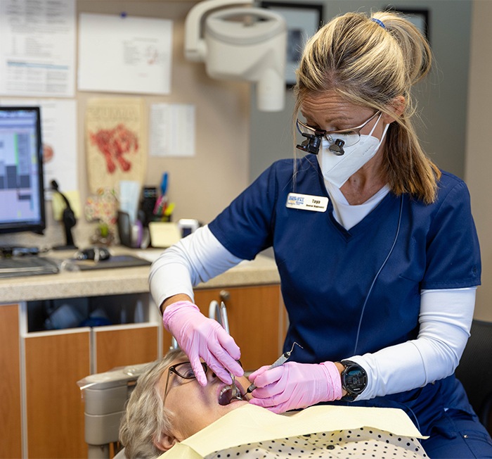 Smiling woman at the dentist for preventive dentistry treatment