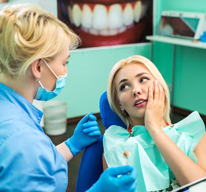 Woman in dental chair for full mouth reconstruction in Minot