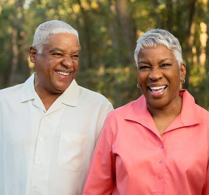 Man and woman laughing after root canal therapy