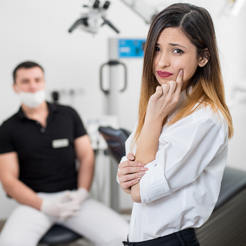 a woman with painful tooth needing a root canal