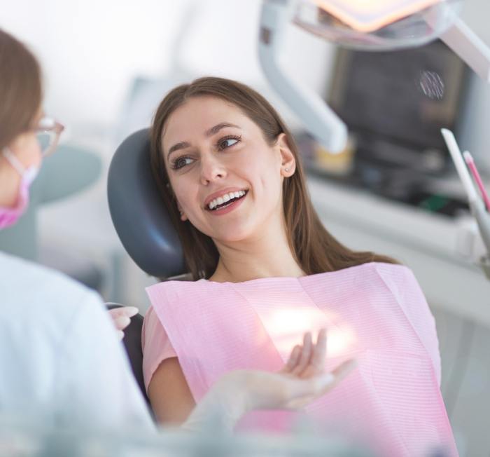 Woman smiling at dentist during dental visit