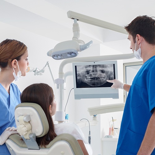 Dentist and patient looking at intraoral images