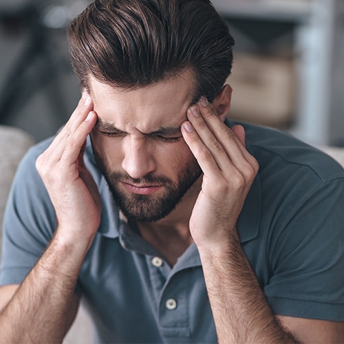 Man with headache before T M J therapy