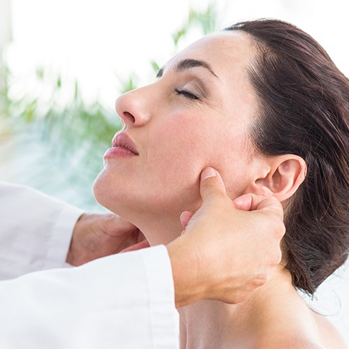 Woman receiving equilibration and occlusal adjustment treatment