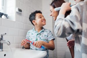 a parent checking to see if their child brushed their teeth properly