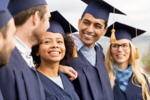 a group of smiling graduates with beautiful teeth