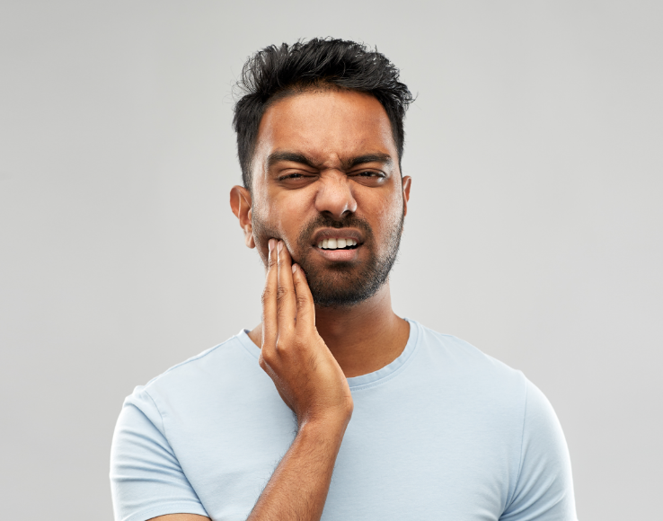 Man holding jaw in pain